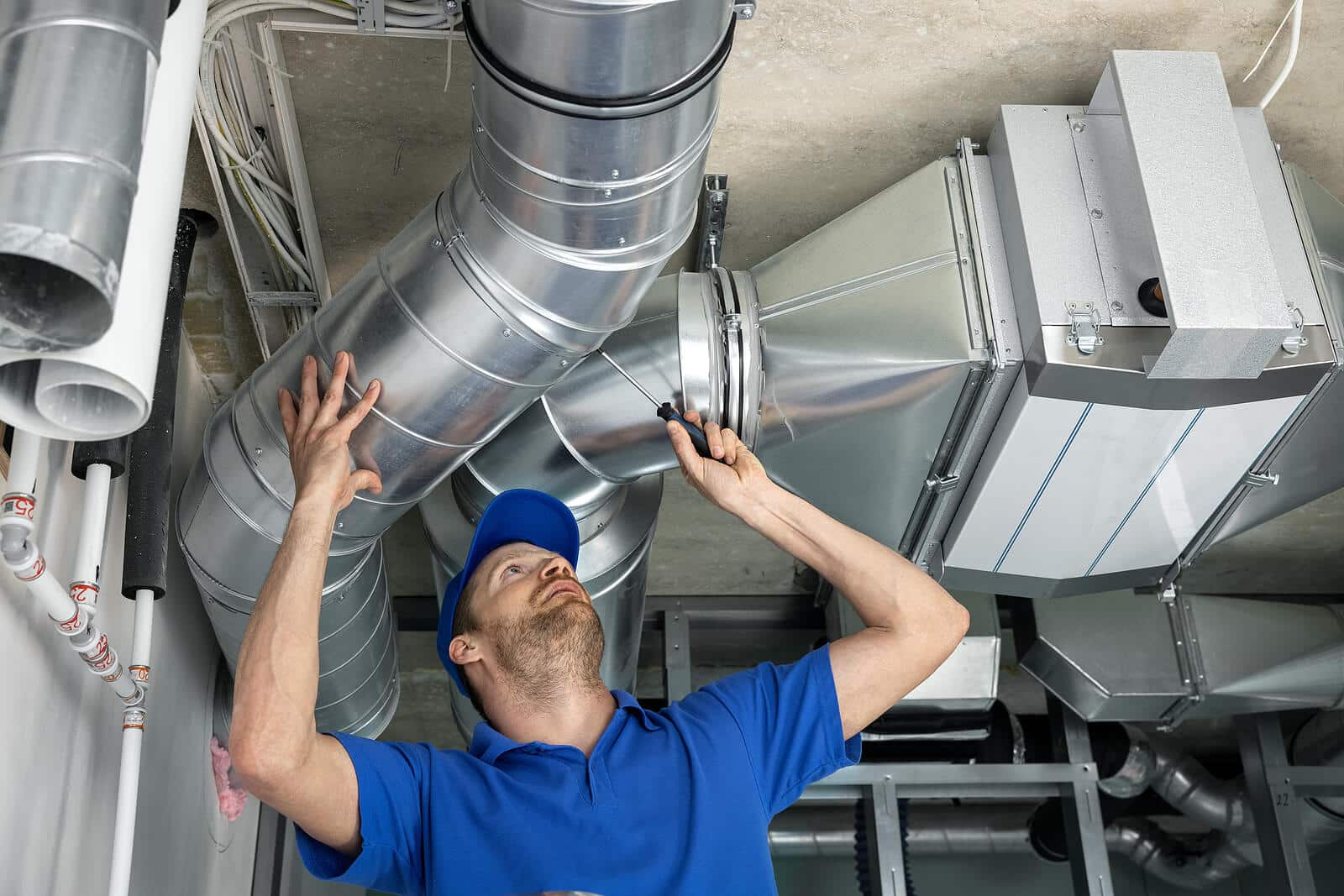 HVAC technician inspecting and repairing air ducts in Burlingame