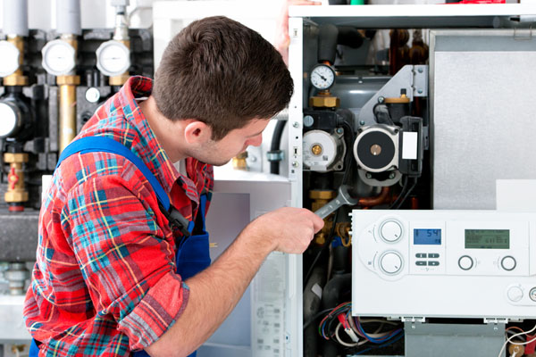 Heating technician repairing boiler controls in Burlingame