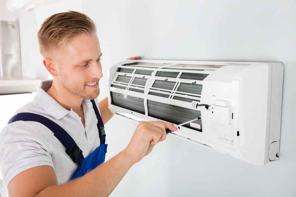HVAC technician maintaining a ductless air conditioner in Burlingame
