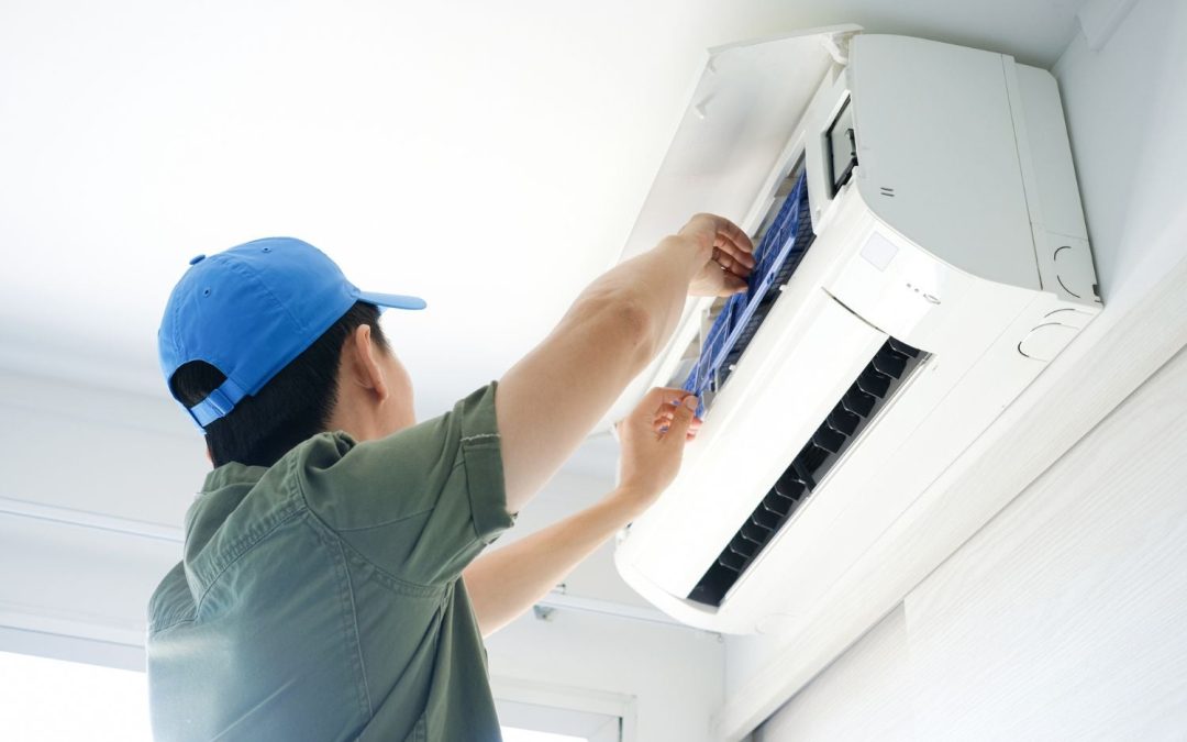 HVAC technician servicing a ductless mini split in Burlingame