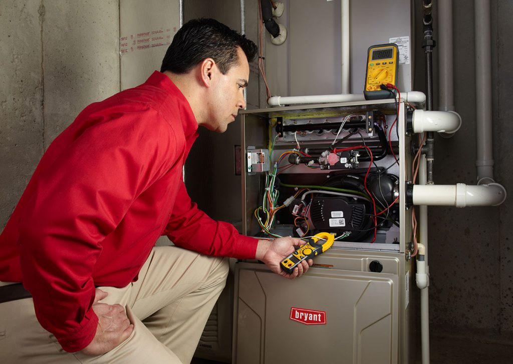 Heating technician diagnosing a furnace repair in Burlingame
