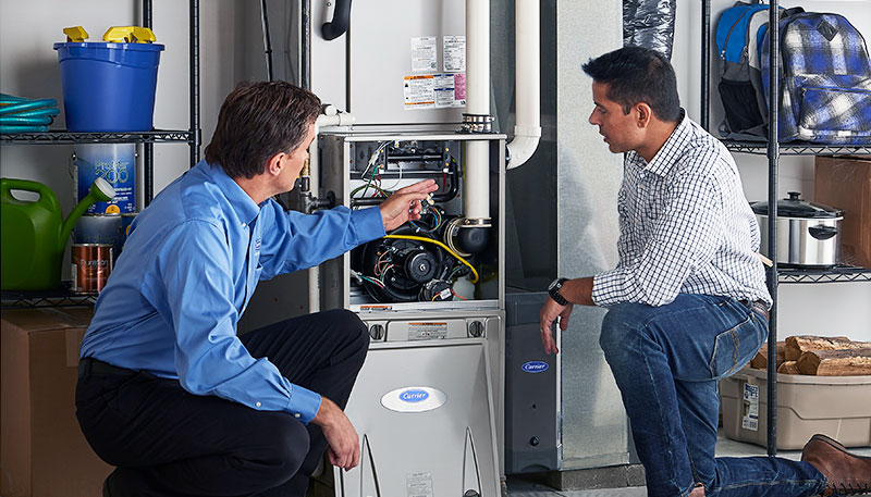 Technician evaluating a furnace for repair or replacement in Burlingame