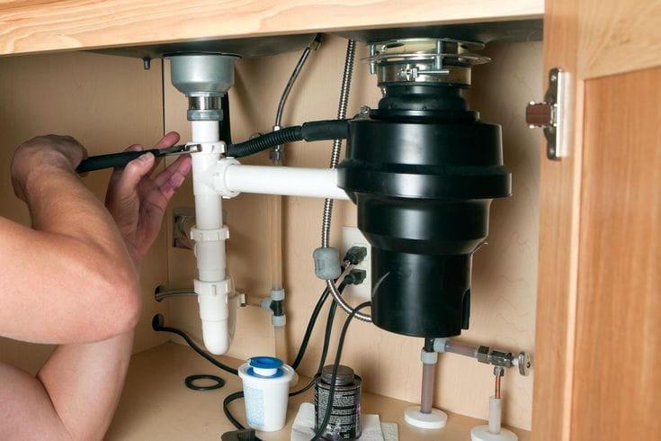 Plumber repairing a garbage disposal in Burlingame