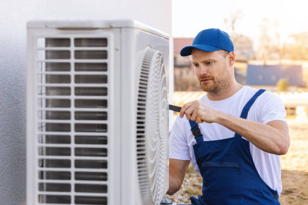 HVAC technician servicing an outdoor air conditioner in Burlingame